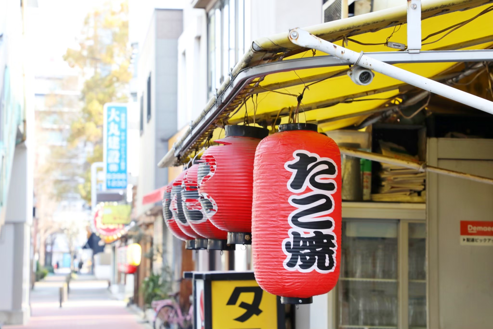 Local takoyaki street with red lanterns near Higashimikuni